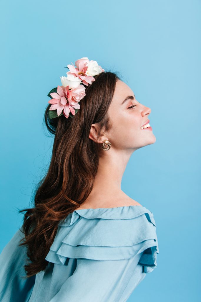 beautiful girl sincerely smiling isolated wall model crown flowers posing portrait profile